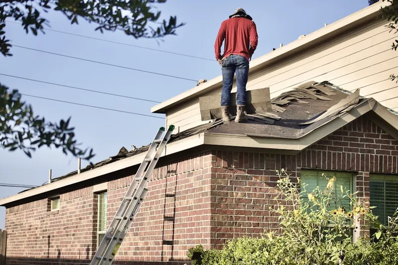 Professional roofer working on a residential roof in Burnett